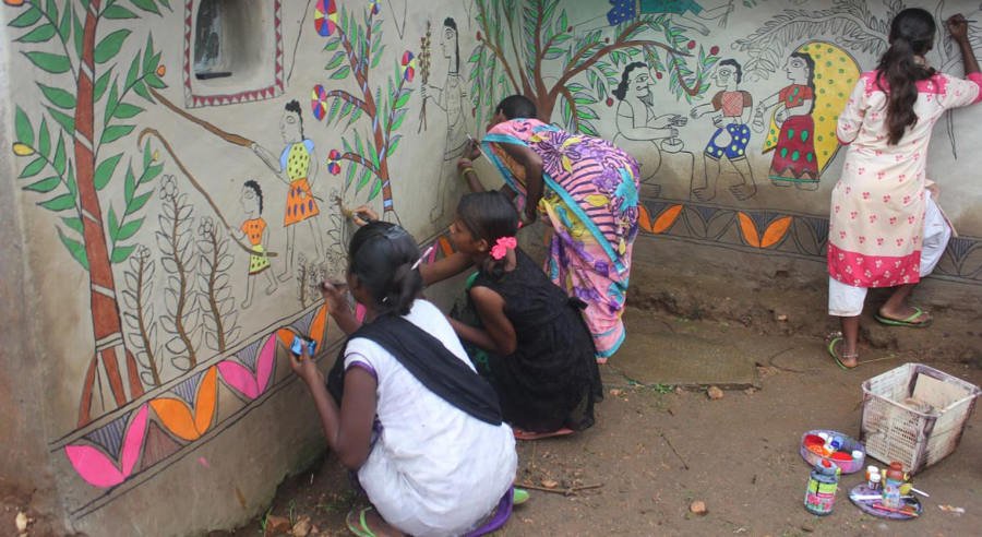 Village walls painted with scenes of tribal life